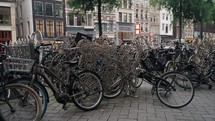 Bicycles Parking At The Street In Amsterdam, Netherlands, Europe. Handheld Shot