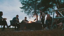 friends sitting around a fire pit 
