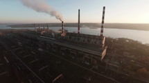 Coal Power Plant Smoke Stacks producing Electricity and Emitting Smoke into Air