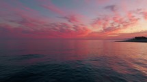 Celestial Spiritual Pink clouds On The Flat Ocean Water
