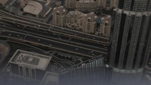Epic and cinematic shot. Drone, aeiral view of highway traffic in downtown Dubai with buildings and skyscrapers from the Burj Khalifa in the middle eastern country of United Arab Emirates in cinematic slow motion.