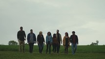 a group walking tougher in a field 