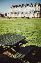 picnic table in a park and view of apartments 