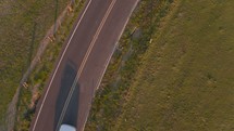 aerial view over cars traveling down a road 