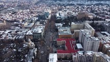 Snowy and sunny city aerial