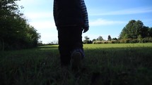 boy walking in a field outdoors 