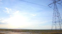 power lines and power poles in a desert 
