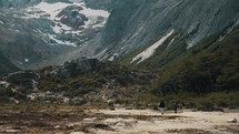 Hikers Walking On The Trails On Mountain Hike In Laguna Esmeralda Near Ushuaia In Tierra de Fuego, Argentina. Wide Shot
