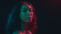 Beautiful Asian Girl Posing Under Neon Light
