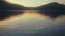 ripples on a still lake at sunset 