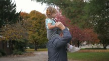 granddaughter on her grandfather's shoulders 