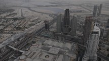 Drone, aeiral, sky view of downtown Dubai buildings and skyscrapers from the Burj Khalifa in the middle eastern country of United Arab Emirates in cinematic slow motion.