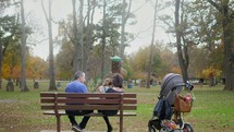 grandfather, grandmother, and granddaughter at the park 