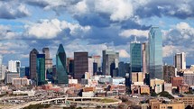 Right to Left Pan Shot of Downtown Dallas Texas Skyline With Beautiful Blue Sky and Clouds Above.	