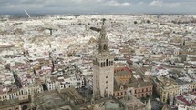 Breathtaking panoramic view of Seville cathedral bell tower and cityscape, Spain. Aerial circling
