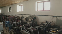 "Empty wheelchairs standing in a abandoned warehouse. 
Healthcare and helping concept"
