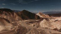 Gravel roads along sandstone mountains in Death Valley