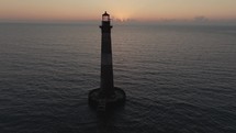 A lighthouse on the  Atlantic Ocean coast of South Carolina during sunrise 