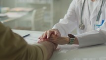 Close-Up of Female Doctor Holding Hands of Patient during Conversation
