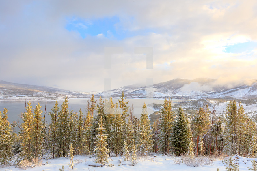 Snowy winter mountain landscape with evergreen trees and lake at Sapphire Point Overlook, Colorado