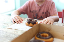a boy eating a donut 