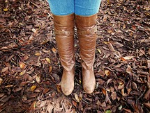 leather boots standing in fall leaves 