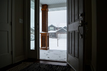 open front door with view of snow 