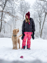 a woman and her dog in snow 
