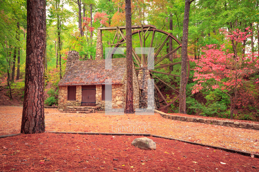 Stone building with water wheel in the fall