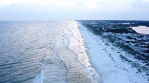 aerial view over a white sand beach 
