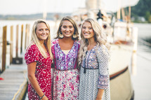 women standing on a boat dock at a marina 
