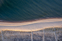 aerial view over a beach shoreline 