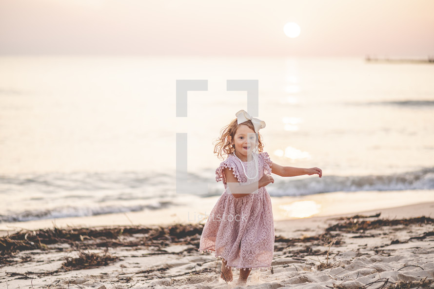 little girl running on a beach