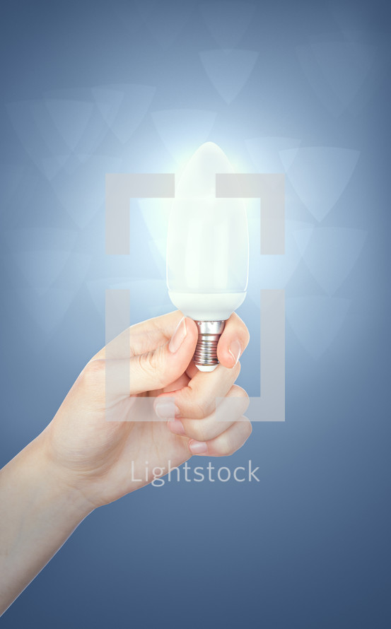a man holding up a lightbulb 