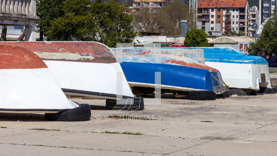 Boats being stored upside down on a sidewalk near Old Town Budva, Montenegro
