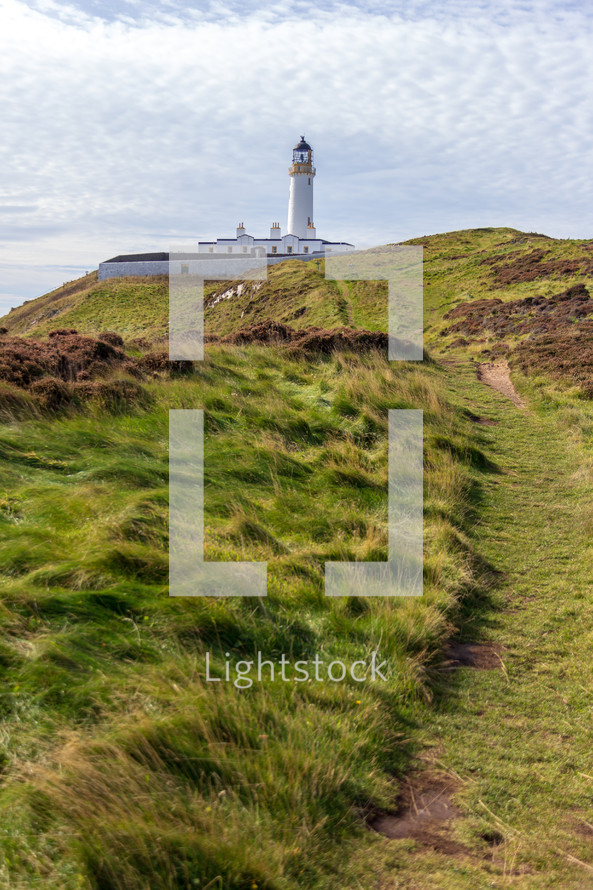 Trail leading to the Mull of Galloway lighthouse in Dumfries and Galloway, Scotland, United Kingdom under a blue sky with white clouds
