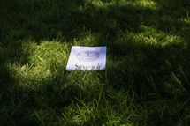 A commencement bulletin in grass