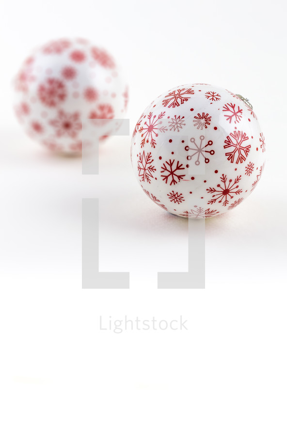 Red and white Christmas balls on a white background.