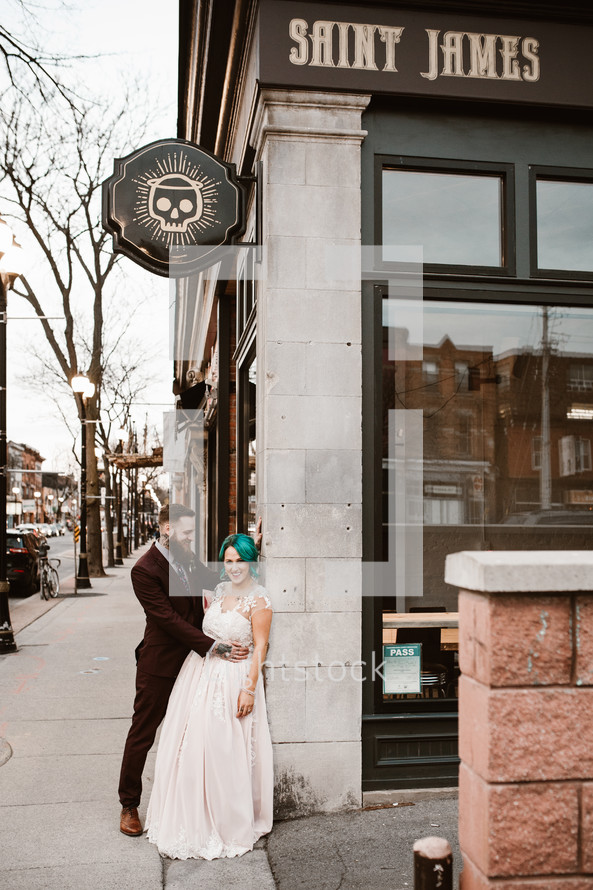 bride and groom on a downtown sidewalk 