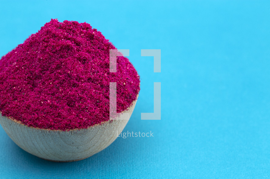 dragonfruit powder in a wooden bowl 