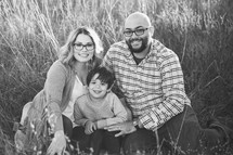 family portrait in a field of tall grasses