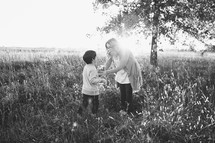 mother and son in a field of tall grasses 
