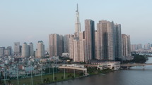 Drone aerial shot of modern buildings in Ho Chi Minh city and Saigon river . Cityscape background, b-roll shot
