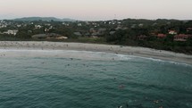Aerial View Of Crowded Beach During Summer In Puerto Escondido, Mexico - drone shot	