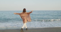 Girl walk on the beach near the ocean in summer