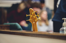 guitar leaning against a church pew 