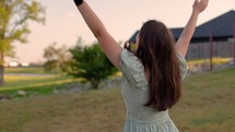 Girl Worshipping Outside at Sunset