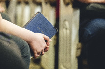 Teenager holding a Bible