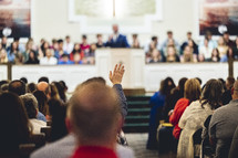 Man, raising his hand during a worship service