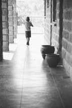 boy child walking down a hall 